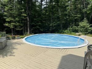 outside swimming pool with large deck